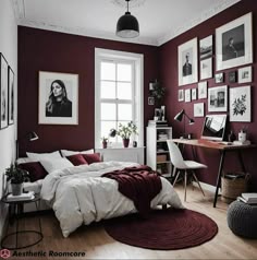a bedroom with red walls and pictures on the wall above the bed, along with a rug