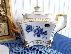 a blue and white tea pot sitting on top of a table