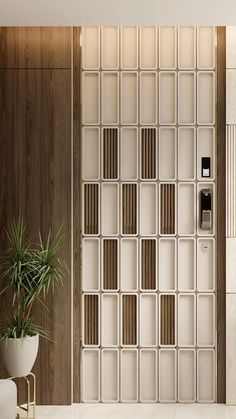a bathroom with a plant in the corner and a toilet on the other side, next to a wooden paneled wall