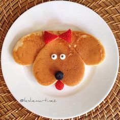 a white plate topped with pancakes shaped like a dog