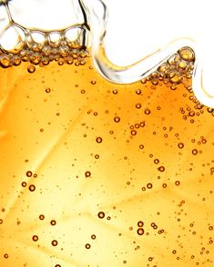 A close up of Jakeman's Amber Maple Syrup with floating bubbles.