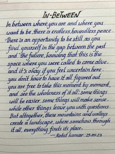 a handwritten poem written in blue ink on lined paper with the words, in between where you are and where you stand