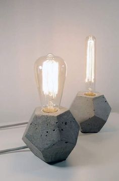 two concrete lamps sitting next to each other