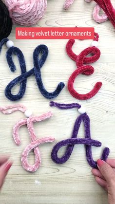 someone is making letters out of yarn on the table