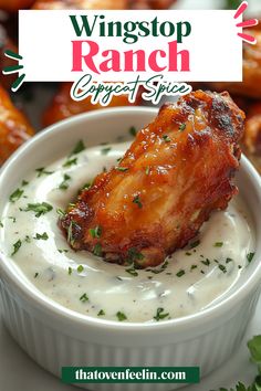 a white bowl filled with chicken wings covered in ranch sauce
