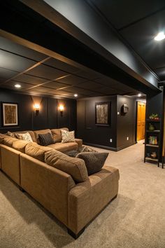 a living room with couches, lamps and pictures on the wall in front of it