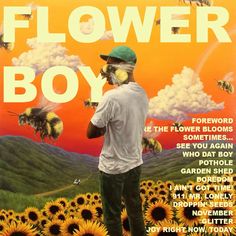 a man standing in front of sunflowers with the words flower boy on it