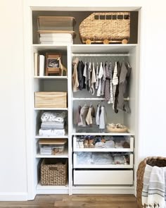 a white closet filled with lots of clothes and baskets on top of it's shelves