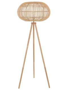 the bamboo floor lamp is standing on a wooden tripod
