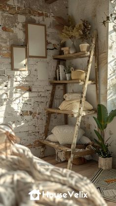 a ladder leaning up against a brick wall next to a bed with pillows and blankets
