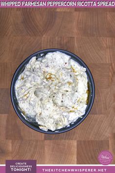 a bowl filled with whipped parmesan on top of a wooden table