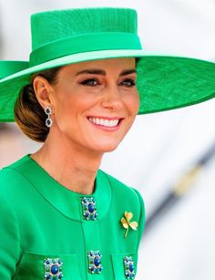 a woman wearing a green hat and smiling
