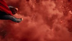 a man flying through the air while wearing a red cape