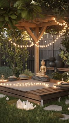 a buddha statue sitting on top of a wooden platform in the middle of a garden
