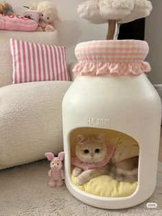 a cat in a house with stuffed animals