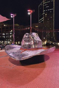 a large hat sitting on top of a metal bench
