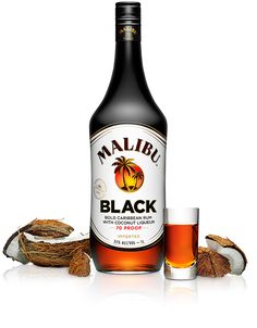 a bottle of malubu black next to some coconuts and a shot glass