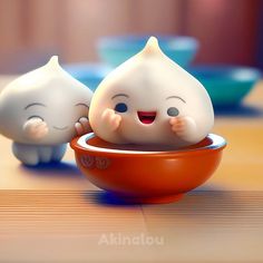 two small plastic toys sitting in a bowl