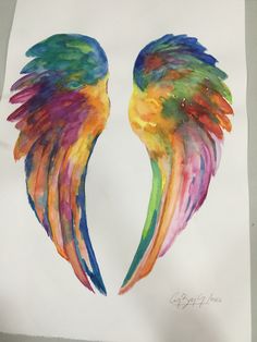 two colorful wings painted on white paper with watercolor pencils in the middle and bottom