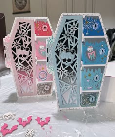 three boxes with cut out designs on them sitting on a table