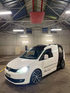 a white van parked in a parking garage
