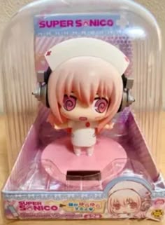 a toy with headphones on it sitting in a plastic case next to a wall