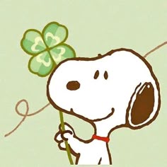 a cartoon dog holding a four leaf clover