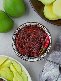 two bowls filled with food next to sliced apples