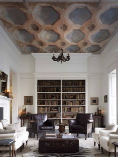 a living room filled with furniture and a book shelf