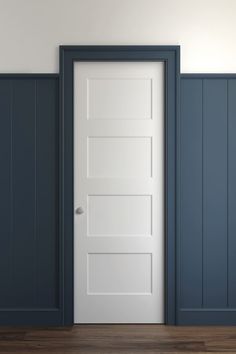 an empty room with a white door and blue walls