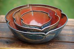 three bowls sitting on top of a wooden table