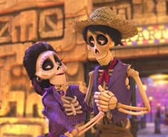 two skeletons dressed in costumes standing next to each other