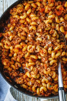 a spoon full of macaroni and cheese with meat