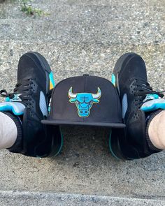 Bulls hat with Air Jordan 5 Aqua sneakers placed on the ground.