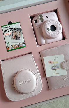 a pink box with a camera and other items in it, including a card case