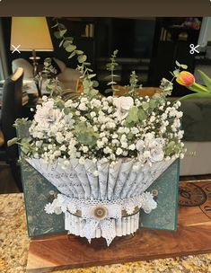 a bouquet of flowers sitting on top of a wooden table