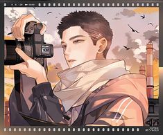 a man holding a camera up to his face with birds in the sky behind him