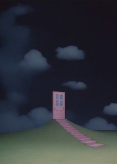 a pink door sitting on top of a green hill