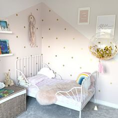 A pretty pink, grey and gold young girls bedroom.