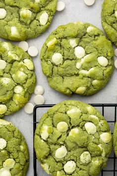 green cookies with white chocolate chips on a cooling rack