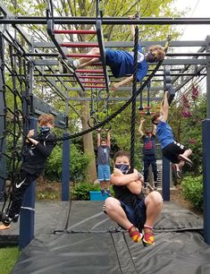 some kids are doing tricks on a trampoline