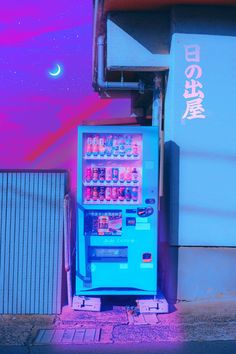 a blue vending machine sitting next to a building