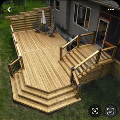 a large wooden deck with stairs and railings