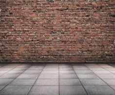 an empty room with a brick wall and tiled floor, in the middle of it
