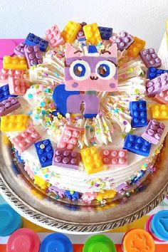 a birthday cake decorated with legos and decorations
