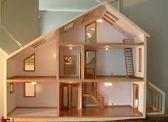 a doll house is shown with all the furniture in it's own room and stairs