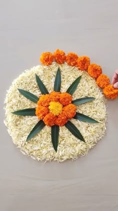 an arrangement of flowers is placed on the ground