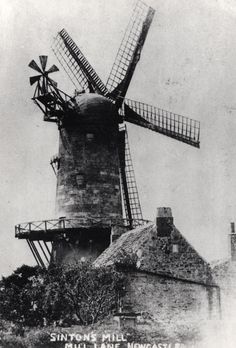 an old black and white photo of a windmill