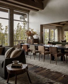 a living room filled with furniture and large windows