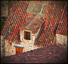 an old building with red tiled roof tops